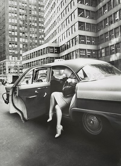 Woman exiting a Taxi