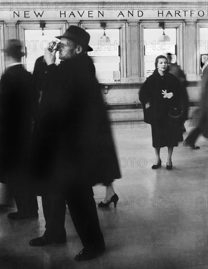 People in front of ticket windows for New York