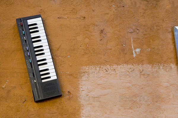 Small electronic keyboard mounted to wall