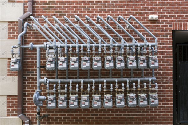 Two Rows of Utility Meters against Brick Wall