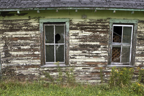 Old Barn with Two Broken Windows and Peeling Paint