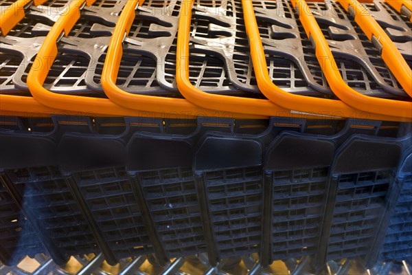 Detail of Row of Shopping Carts with Orange Handles