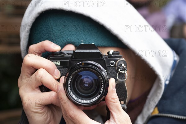Man looking through Camera Lens