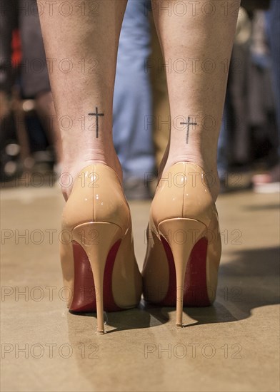 Rear View of High Heel Shoes and Cross on Woman's Ankles