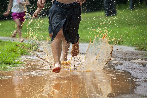 Children running through Water Puddle