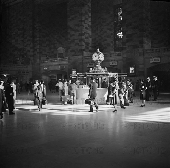 Group of People gathered around Information Booth