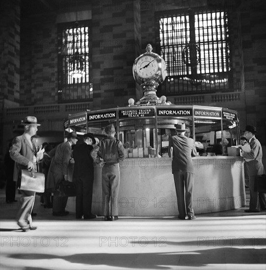 Group of People gathered around Information Booth