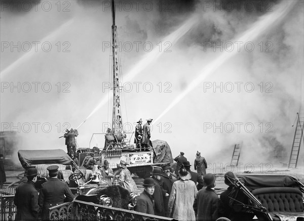 Fireman spraying water on burning building