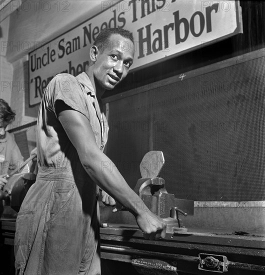 Young Adult Man receiving training in machine shop practice