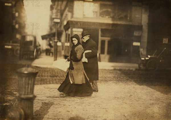 Woman carrying Box of Artificial Flowers Home