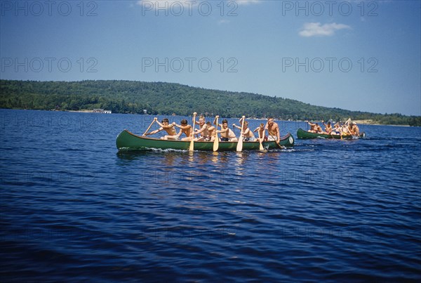 Camp Boys rowing Canoes