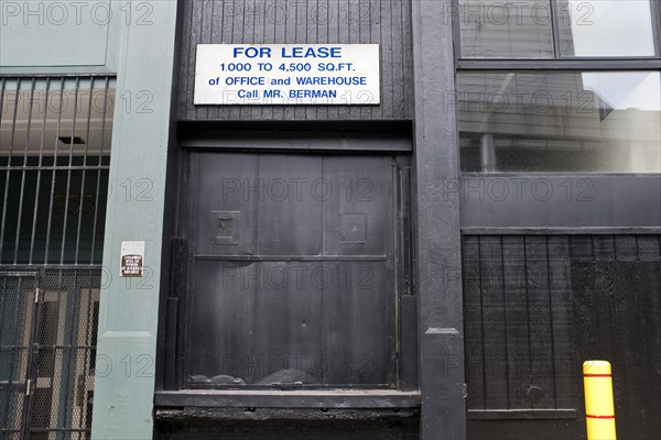 For Lease Sign above Black Loading Dock Door