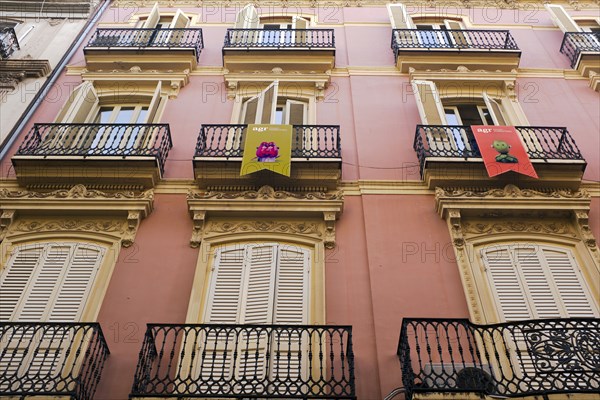 Low Angle View of Building Exterior with Large Windows and Shutters