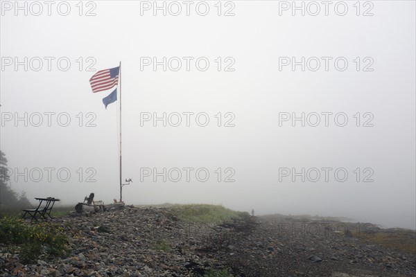 American Flag blowing in Wind on Foggy Beach
