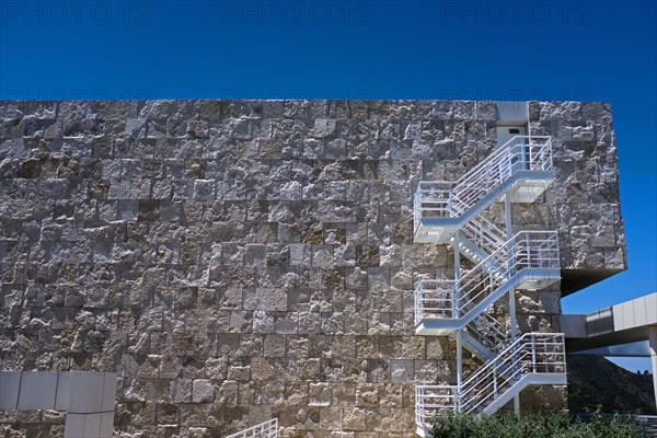 White Fire Escape against Stone Wall