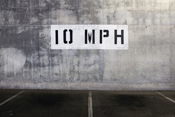 10 mph Speed Limit Sign painted on Wall of Parking Garage