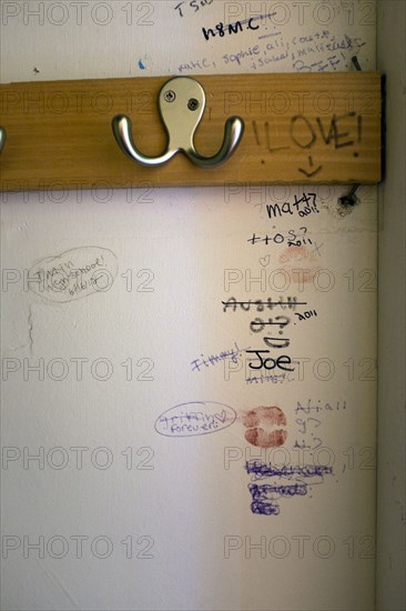 Clothes Hook and Graffiti inside Teenager's Closet