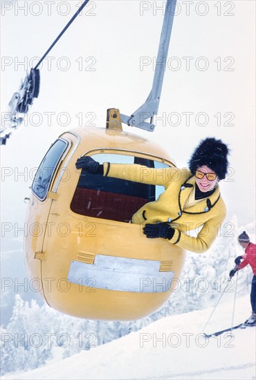 Woman leaning out of Ski Gondola