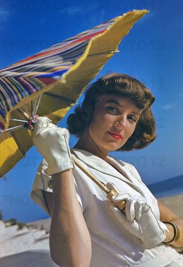 Young Woman in White Dress with Sun Umbrella