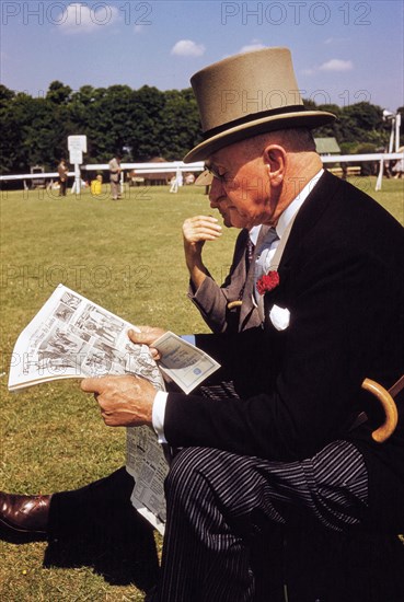 Man in Formal Attire reading Newspaper