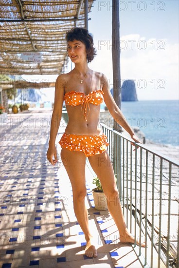 Woman wearing Orange Two-Piece Bathing Suit with Polka Dots