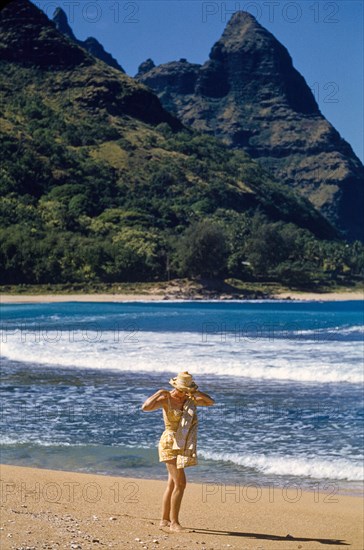 Solitary Woman walking along Beach