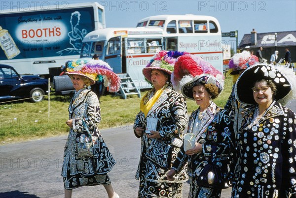 Four Women wearing Jackets and Skirts with Different Sized Buttons sewn onto them attending English Derby