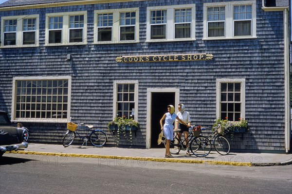 Two Women with Bicycles in front of Cycle Shop