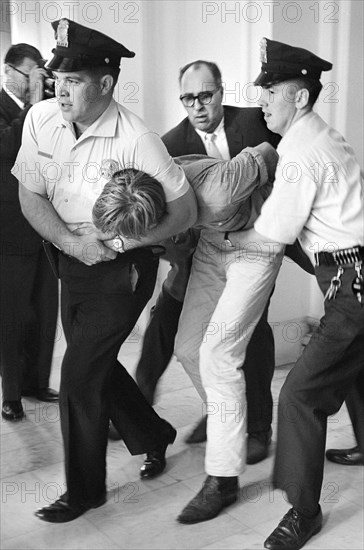 Protester being removed by U.S. Capitol Police officers