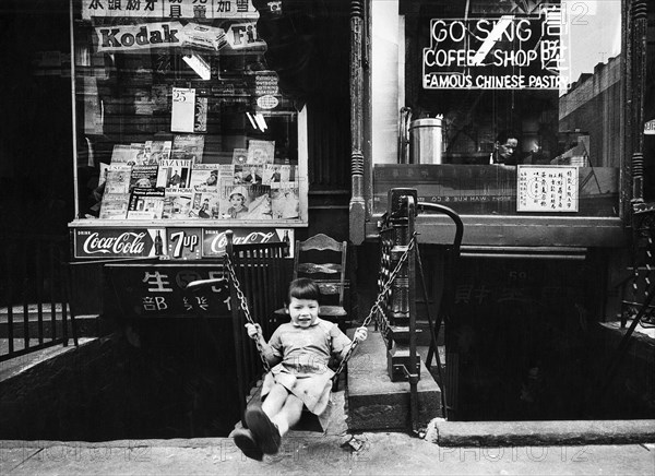 Young Girl Swinging in front of Go Sing Coffee Shop