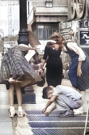 Children inspecting Sidewalk Grate