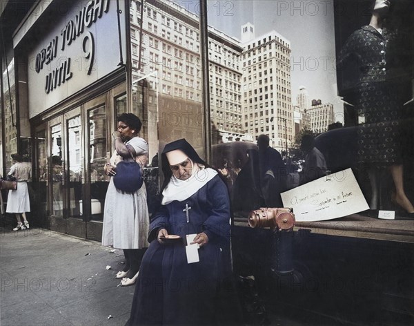 Nun sitting on Sidewalk seeking Charity