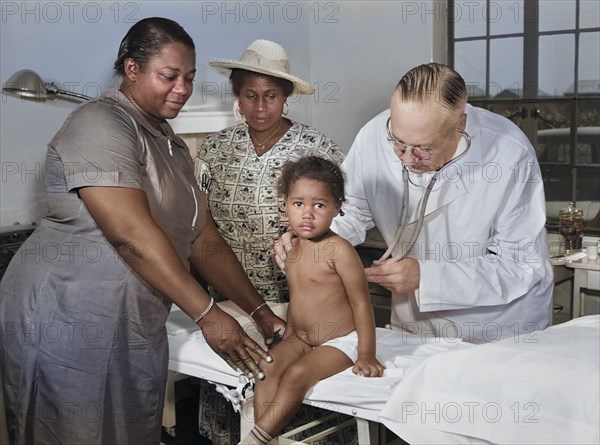 Dr. William J. Buck examining Child