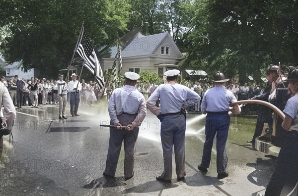 Men holding American Flags in protest of integration of Central High School