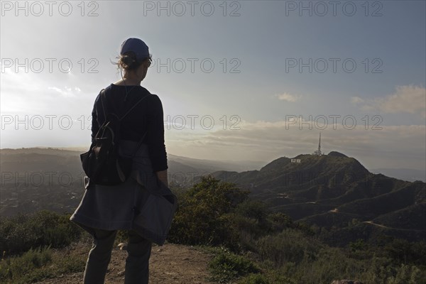 Rear View of Hiker viewing Hollywood Sign and Santa Monica Mountains in the Distance