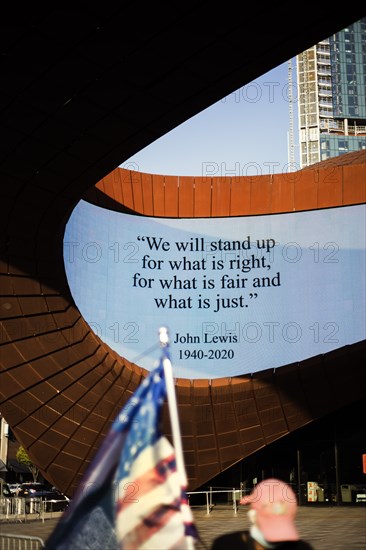 John Lewis Quote on digital sign with American flag in foreground