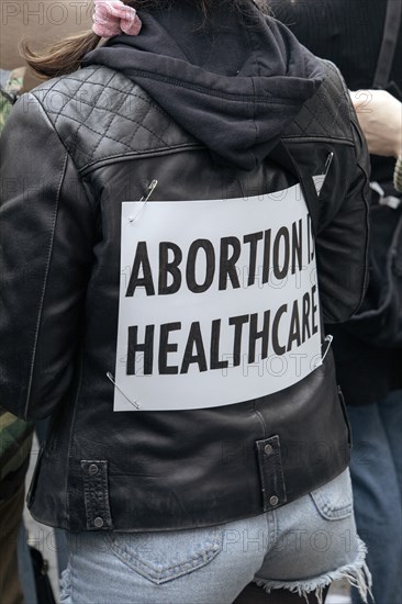 Abortion is Healthcare Sign pinned to Leather Jacket at Abortion Rights Rally