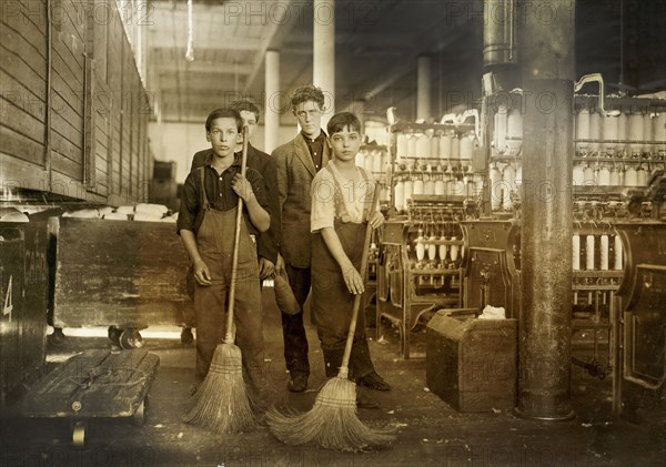 Young sweepers in spinning room of textile mill
