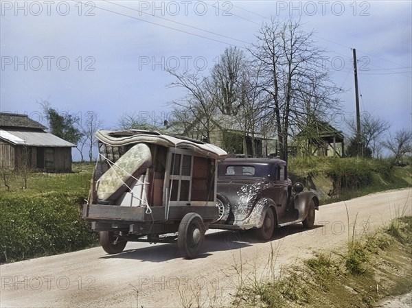 Family with trailer of belongings being relocated due to construction of Camp Croft