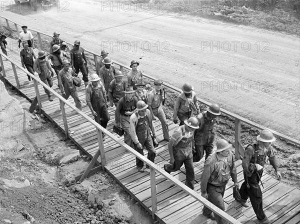 Worker's changing shifts during construction of Douglas Dam