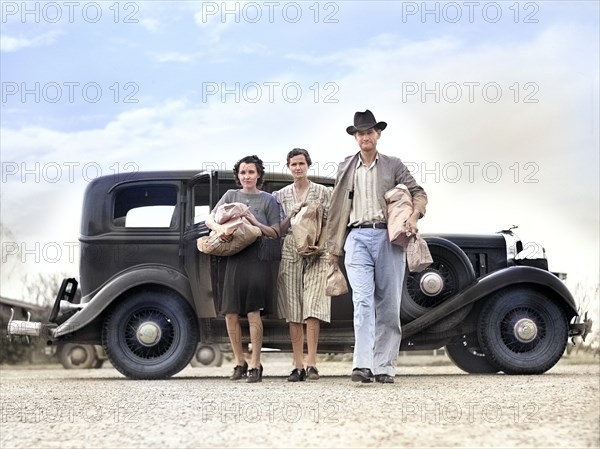 Three people returning from shopping to Farm Security Administration Migratory Labor Camp