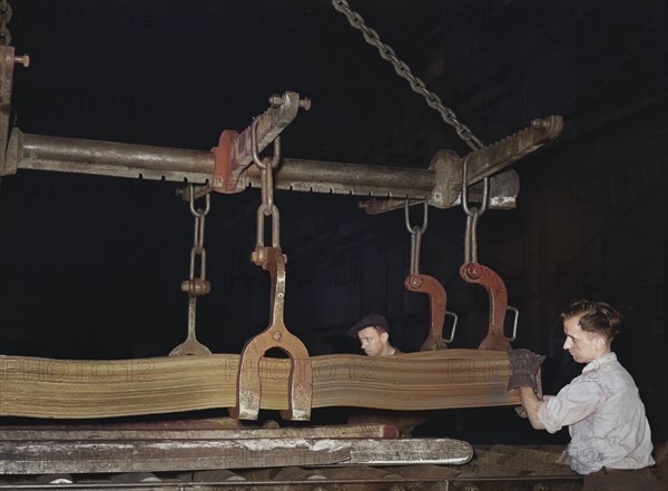 Steel workers loading sheet metal