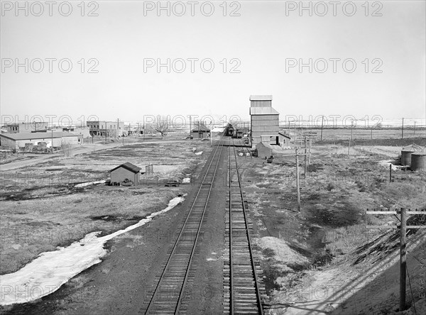 Railroad tracks through rural landscape