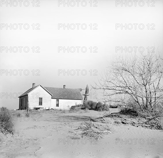 Shifting drifts of soil forcing farmer to abandon his home