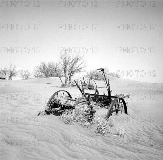 Buried farm equipment after dust storm