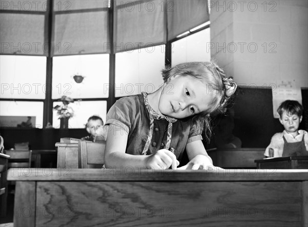 Young girl drawing picture at nursery school