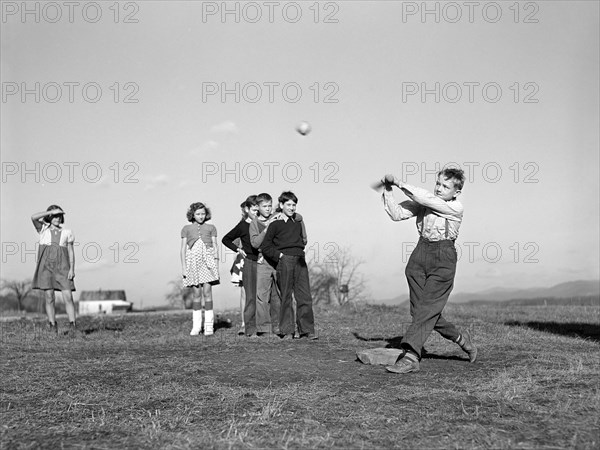 Children playing baseball game during afternoon play period