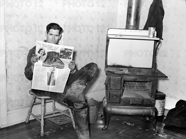 Unemployed coal miner reading newspaper