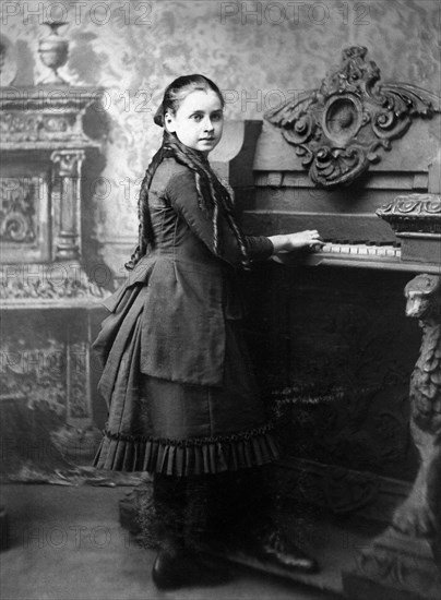 Young Girl playing Harmonium