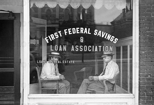 Two men sitting in window